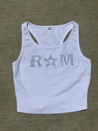 Close-up of a white ribbed crop top with rhinestone "RM" lettering and star worn with jeans – urban glam style by Renegade Mafia