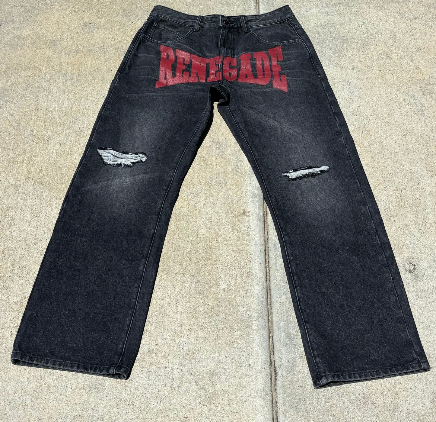 Front jeans flat lay:
“Black denim jeans with bold red ‘RENEGADE’ print across the front and distressed thighs by Renegade Mafia”