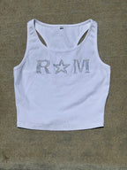 Close-up of a white ribbed crop top with rhinestone "RM" lettering and star worn with jeans – urban glam style by Renegade Mafia