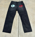 Back view of Renegade Mafia jeans featuring red and blue RM logos on both pockets”